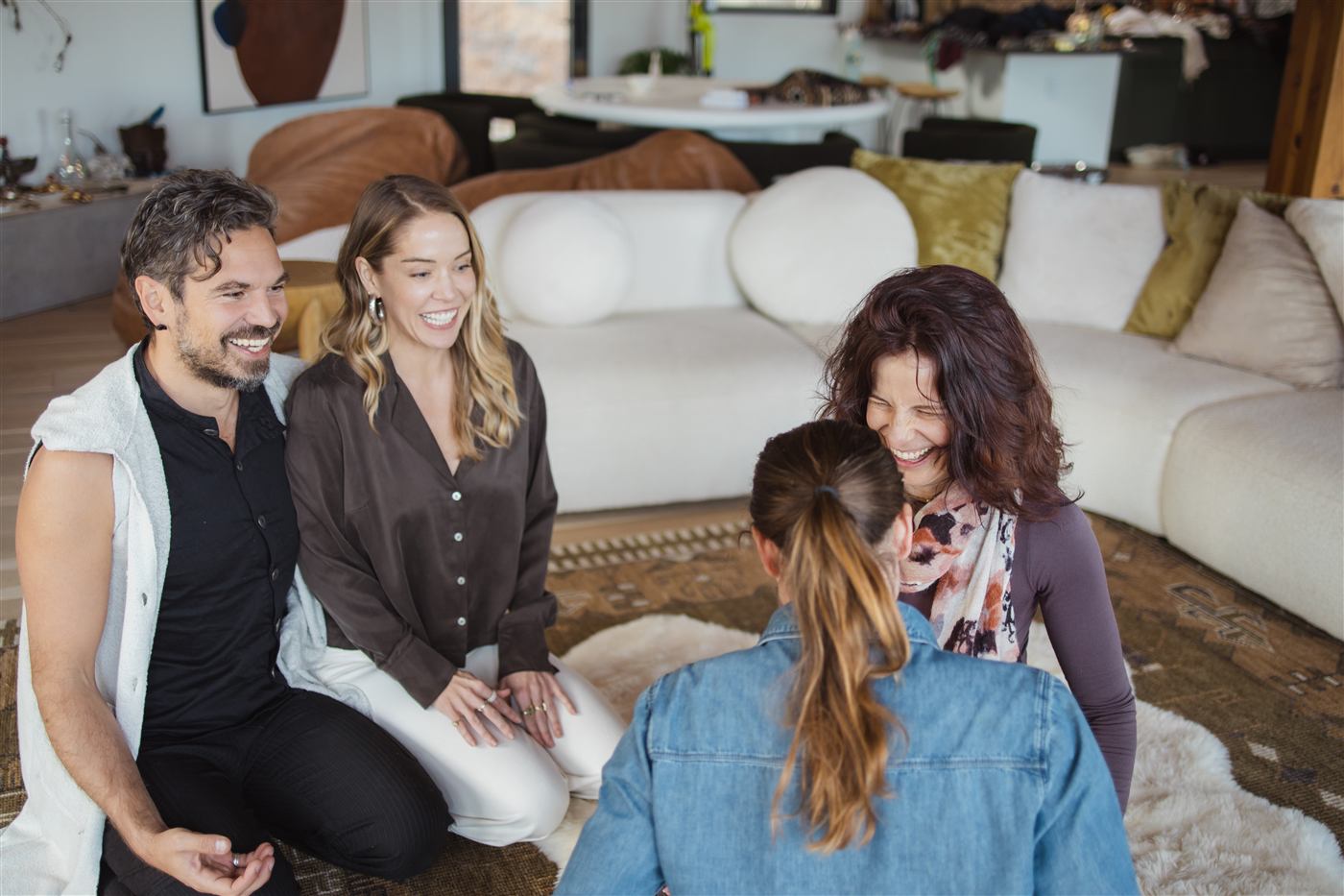 Jen and Atilla holding a circle of people, laughing together